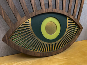 Wood and metallic material sculpture of eye.